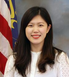 Woman posing in front of American flag