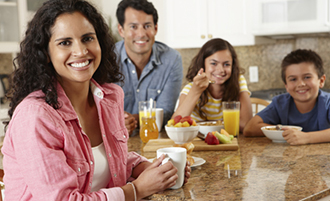 Latina eating breakfast with her husband and two children