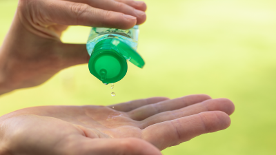 Hands applying sanitizer