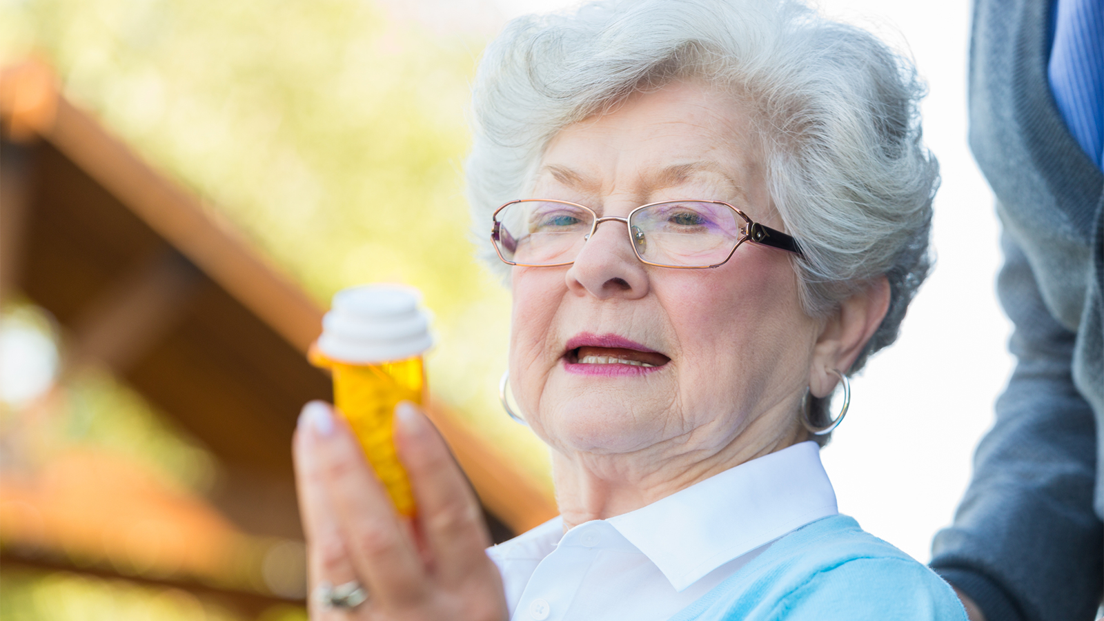 Woman holding pill bottle