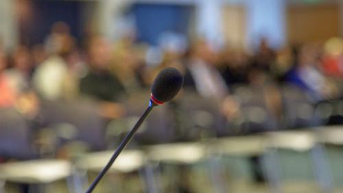Microphone on podium before webinar audience
