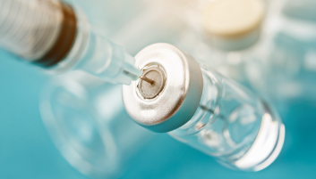 Bottle of vaccine with syringe inserted