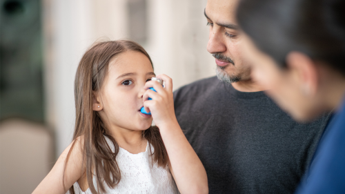 Child using asthma inhaler