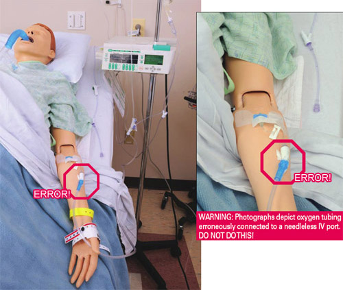 Oxygen tubing erroneously connected to a needleless IV port on mannequin arm