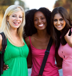Three diverse college women smiling