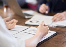 Co-workers writing at a desk