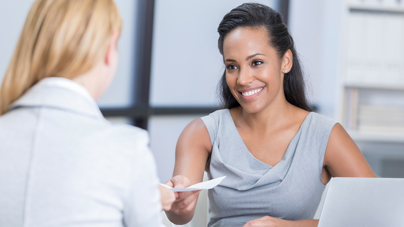 Woman speaking to another woman