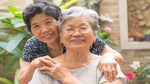 Portrait of Asian female older ageing women smiling with happiness in garden