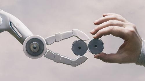 Robot arm and human hand meet, with gears, representing the concept of advanced manufacturing