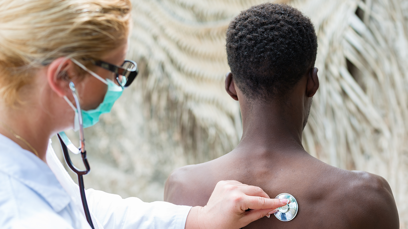 Female doctor listening to the lungs of a patient