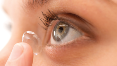 Photo of someone inserting a contact lens.
