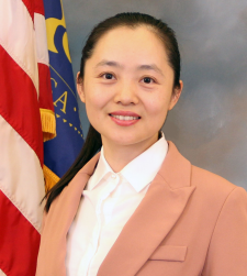 Woman posing in front of American flag