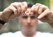 Man breaking cigarette