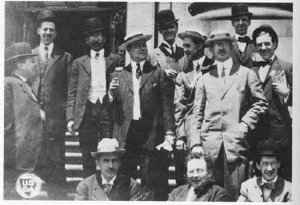 Male inspectors on the steps in front of a building.