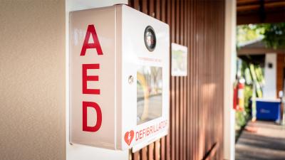 Automated External Defibrillator (AED) placed on the wall in a public location.