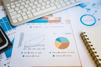 High Angle View Of Charts On Desk