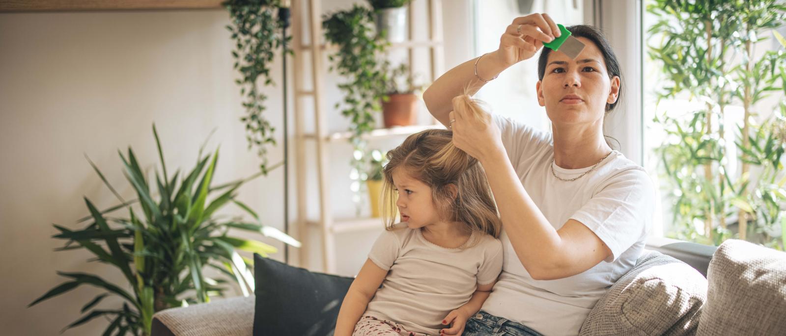 Woman checking child for head lice