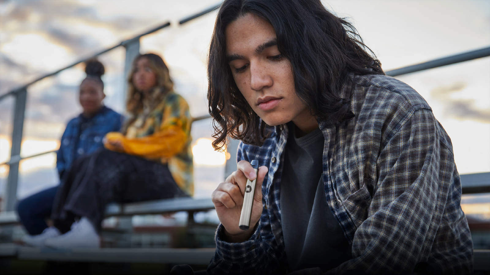 Youth on bleachers vaping