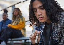 Youth on a bleacher vaping