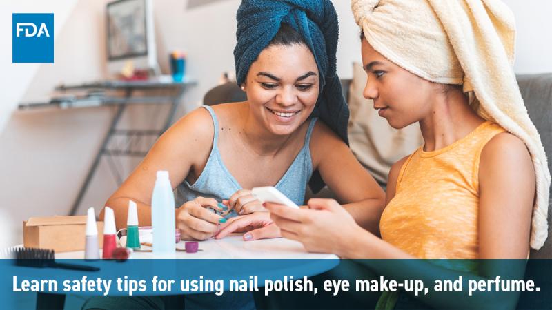 Two college students painting their nails.