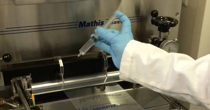 Gloved hand of FDA scientist working with lab equipment at FDA headquarters in White Oak, Maryland