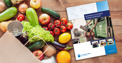 Photo of report "Activities for the Safety of Imported Produce" on table next to bag of various produce.