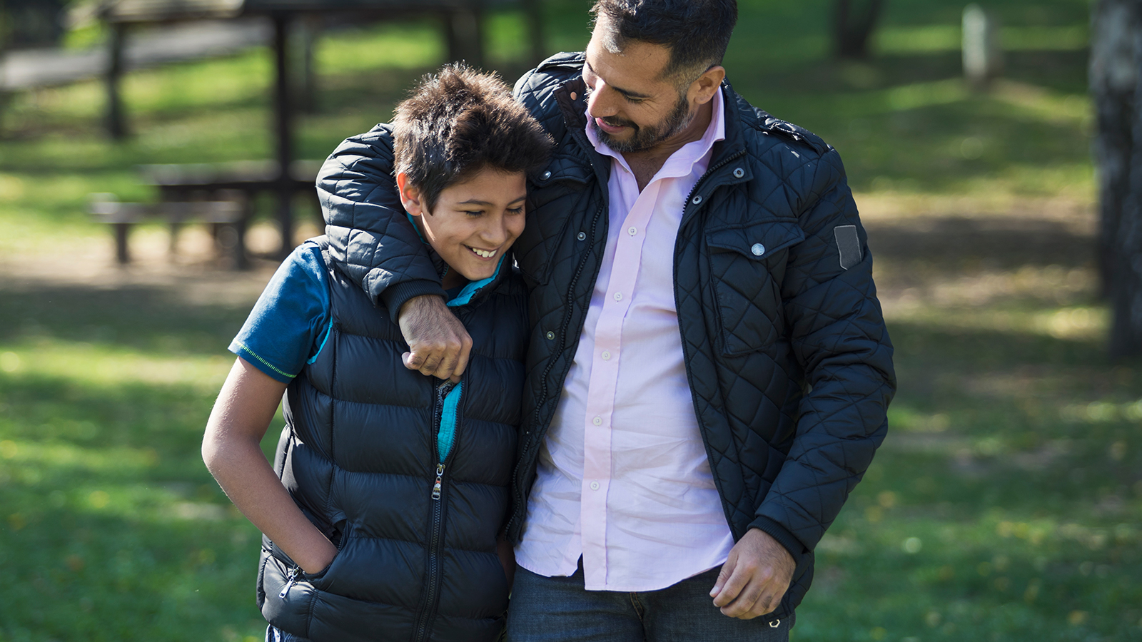 Parent walking with teenage boy