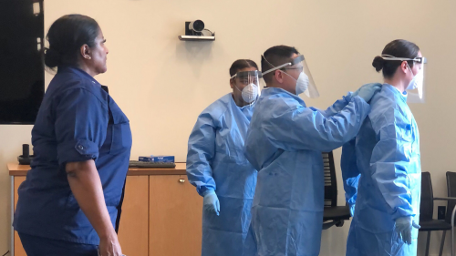 FDA Commissioned Corps officer RADM Estella Jones, DVM, OCET Deputy Director and Co-Chair of the FDA Animal Welfare Council, oversees Commissioned Corps officers as they practice proper fitting of protective items.