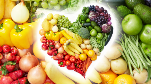 fruits and veggies arranged in the shape of a heart