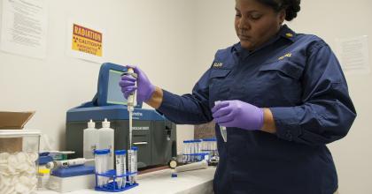 PHS Commissioned Corps Officer analyzing a sample in an international mail facility