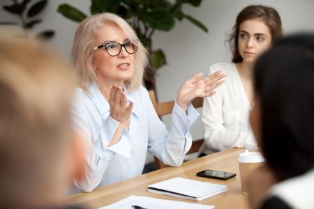 Woman leading discussion at table