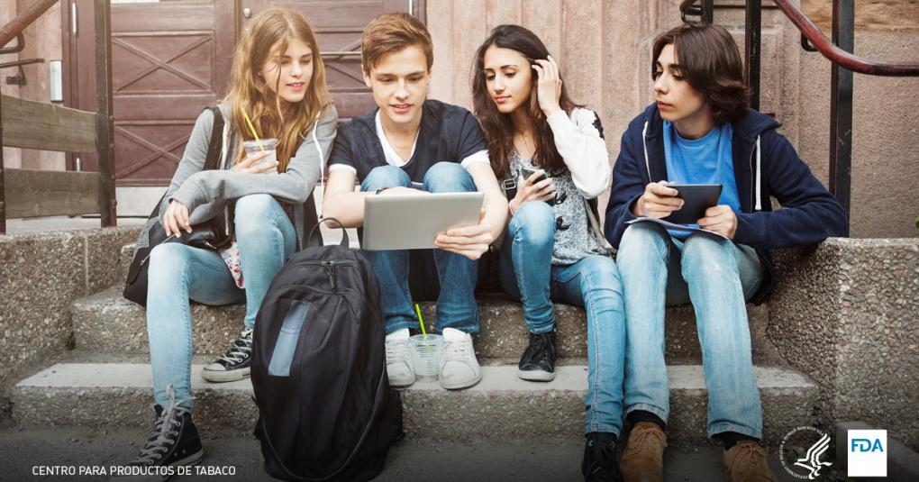 Four students looking at a computer