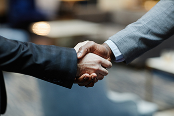 Two people shaking hands, Getty Images