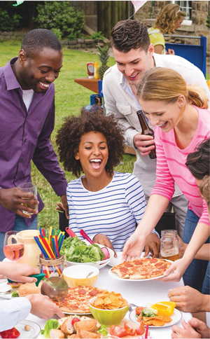 Group of friends at an outdoor party with food.