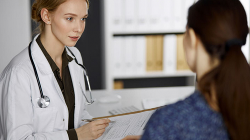 young female doctor talking to her young female patient