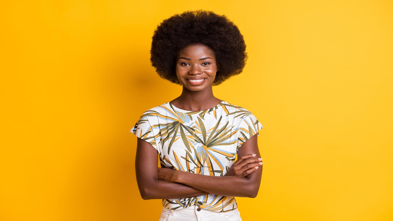 Black lady smiling, yellow background