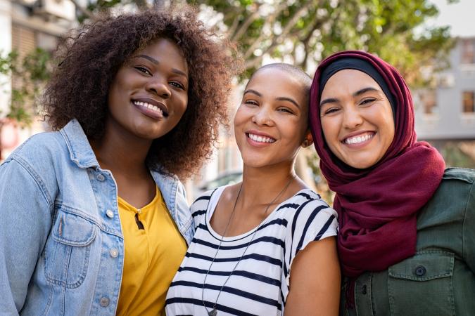 Multiethnic young friends smiling at camera