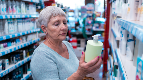 Person looking at product label in store 