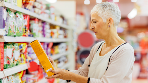 Person reading a label on a food box