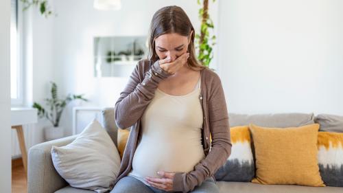 Image of pregnant woman gagging 