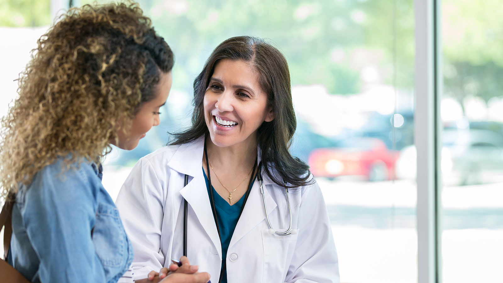 Female doctor speaking with a female patient