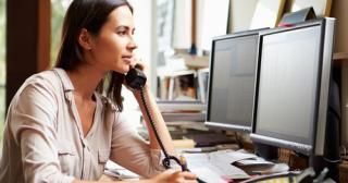 Woman on phone working at computer