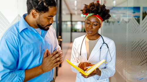 doctor showing notebook to patient