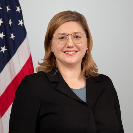 Headshot of Suzanne Roosen with flag