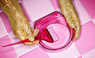 woman mixing hair dye in a bowl