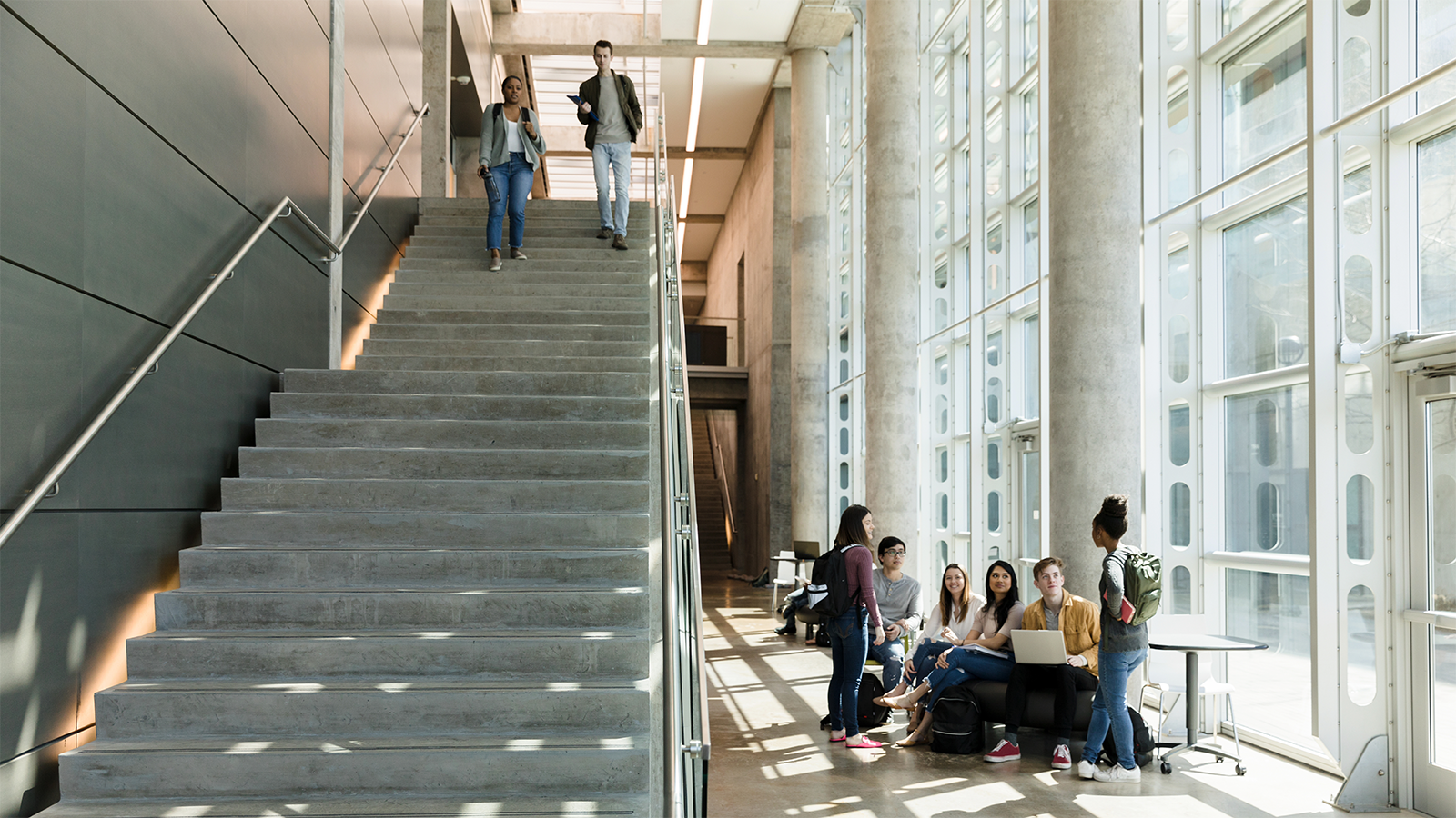 Students walking down stairs; mingling around