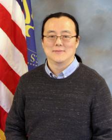 Man posing in front of American flag