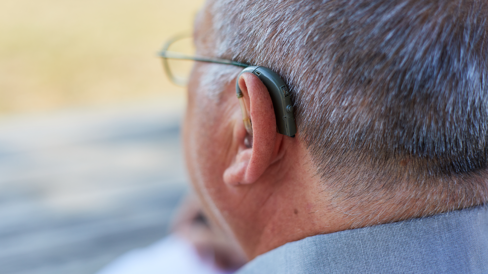 Man with hearing aid in ear