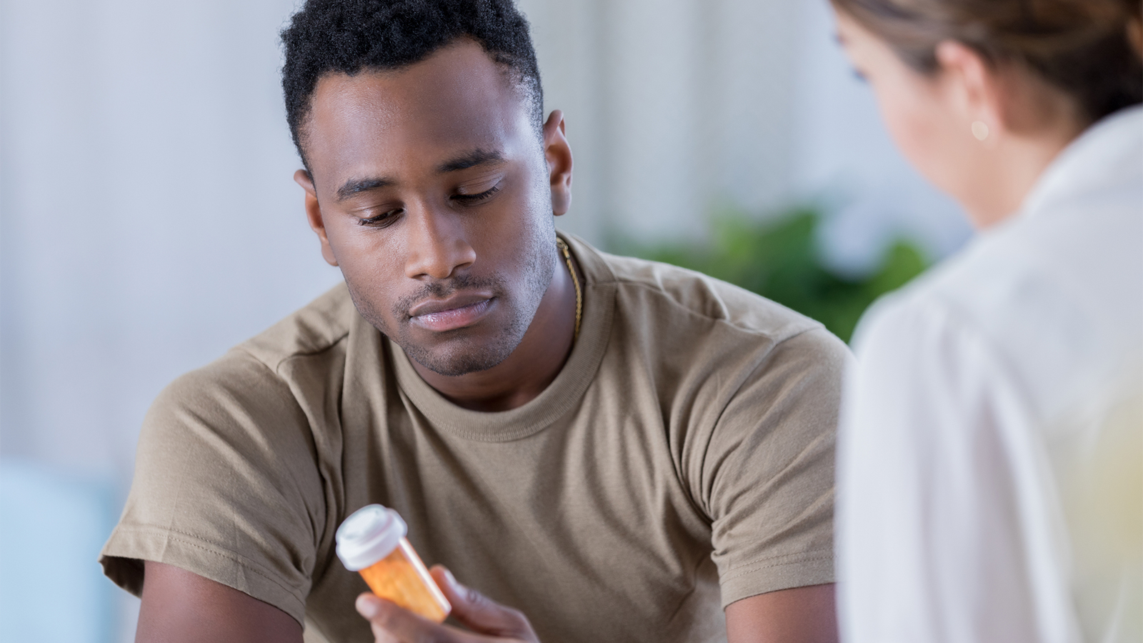 Man holding pill bottle