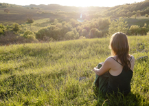 Woman sitting in a sunny field